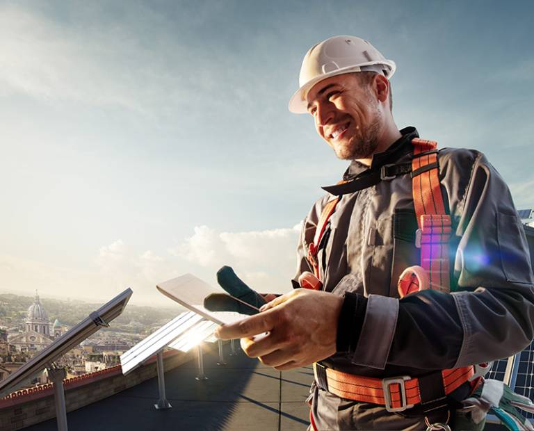 Solar energy engineer using tablet for check power station smiling in roof Solar energy engineer using tablet for check power station in roof
